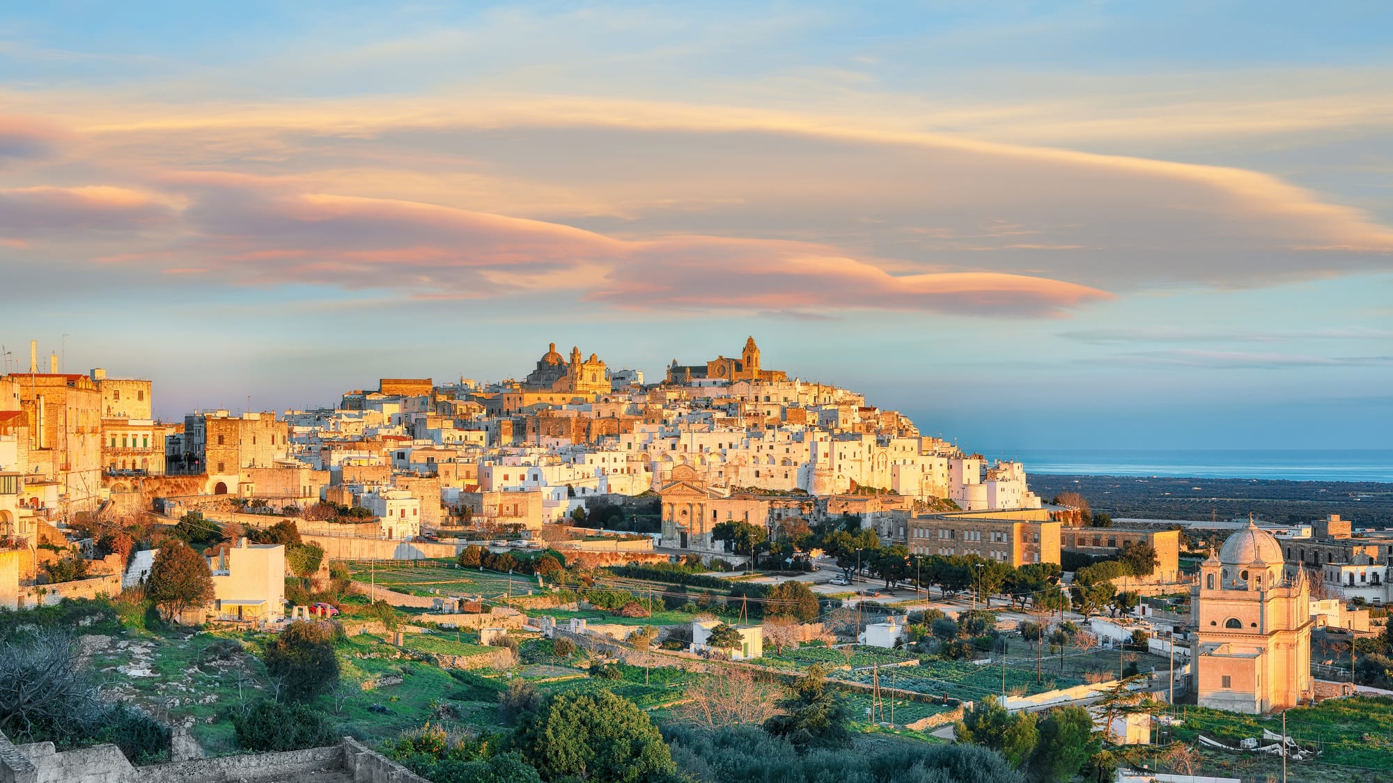 Attractive view on Ostuni white town skyline and Madonna della Grata church