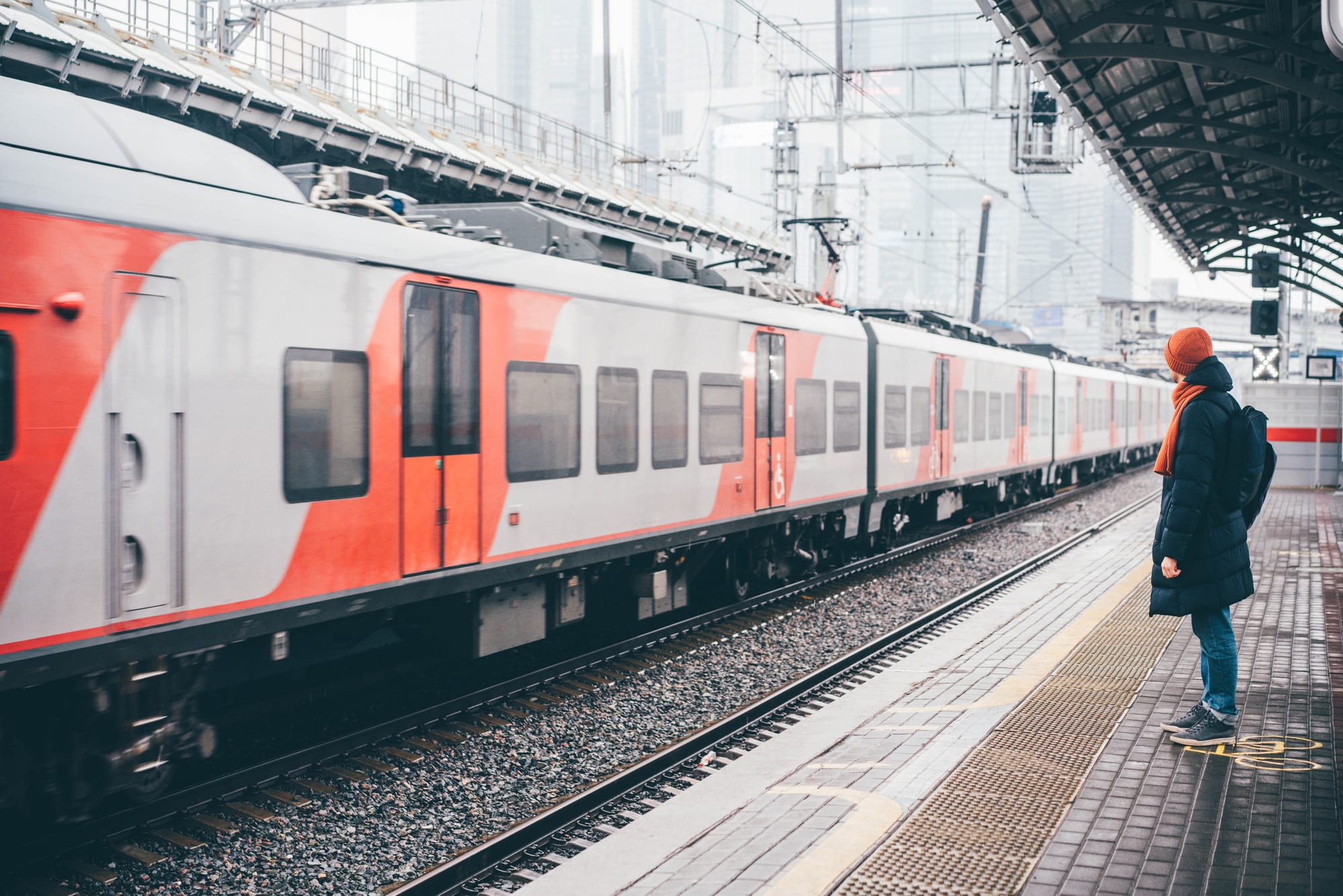 Man standing on a train platform and waiting a train in a train station at Europe.